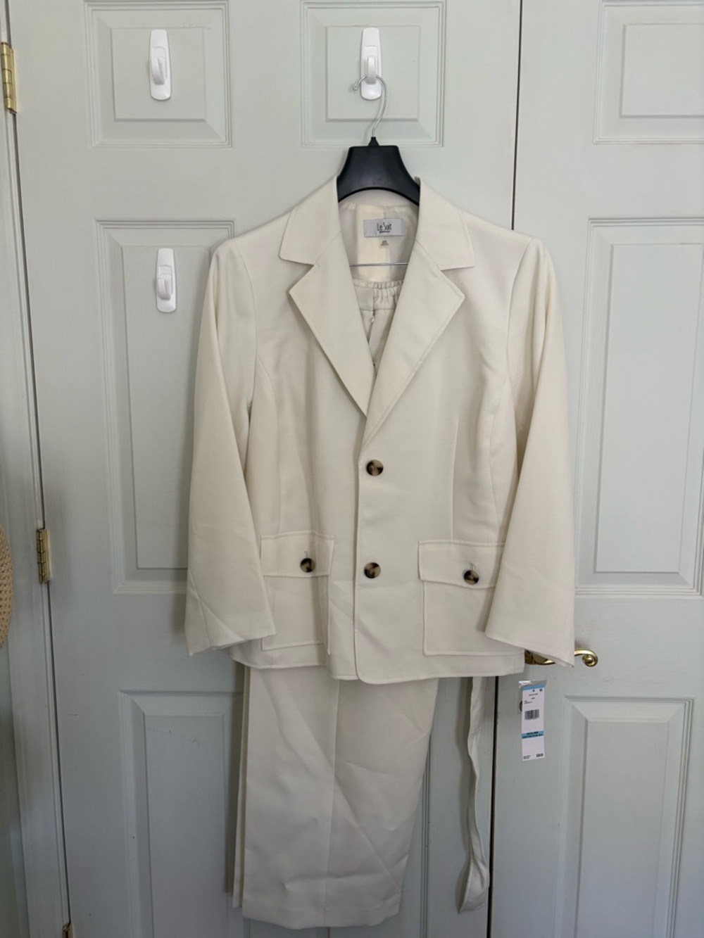 Two-piece woman’s pant suit by Le Suit. NWT. Belted jacket and wide leg pants.